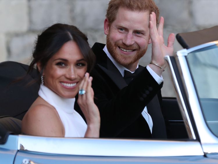  Prince Harry, Duke of Sussex, (R) and Meghan Markle, Duchess of Sussex, (L) leave Windsor Castle in Windsor on May 19, 2018 in an E-Type Jaguar after their wedding to attend an evening reception at Frogmore House. (Photo by Steve Parsons / POOL / AFP) (Photo credit should read STEVE PARSONS/AFP/Getty Images)