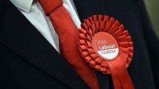 A Labour Party supporter wears a rosette in support of the political party during the election count for Basildon at the Sports Village in Basildon, Essex. PRESS ASSOCIATION Photo. Picture date: Friday May 6, 2016. See PA story POLITICS Election. Photo credit should read: Hannah McKay/PA Wire .