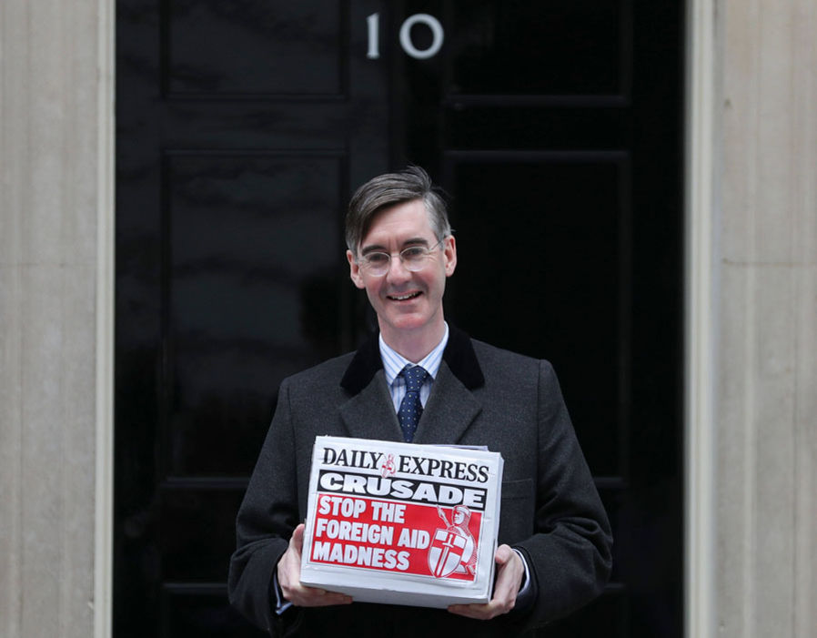 Jacob Rees-Mogg poses as he delivers a petition against the provision of foreign aid at 10 Downing Street in London