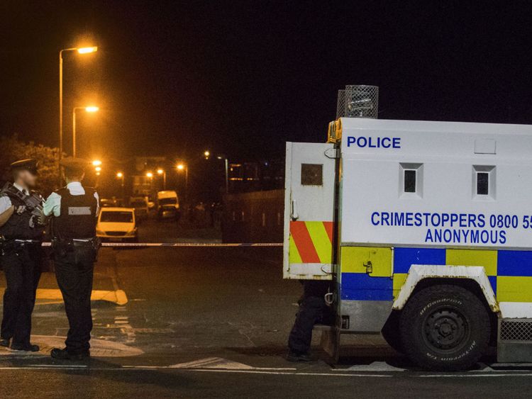 Police stand guard outside the home of Bobby Storey