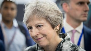 FARNBOROUGH, ENGLAND - JULY 16: British Prime Minister Theresa May speaks with guests as she opens the Farnborough Airshow on July 16, 2018 in Farnborough, England. Theresa May opened the Farnborough Airshow today with a speech pledging £300 million for a variety of research projects for the aerospace industry. Recently Bristol-based firm Airbus said it may have to move premises out of the UK after Brexit. (Photo by Matt Cardy - WPA Pool/Getty Images)
