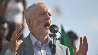 Jeremy Corbyn speaks to demonstrators marching through London during protests against the visit of Donald Trump
