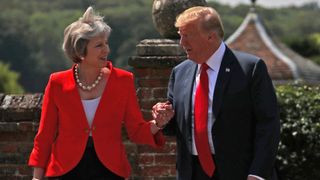Britain&#39;s Prime Minister Theresa May and U.S. President Donald Trump walk to a joint news conference at Chequers, the official country residence of the Prime Minister, near Aylesbury, Britain, July 13, 2018