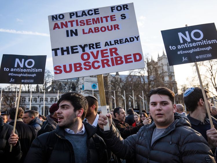 MARCH 26: Protesters hold placards as they demonstrate in Parliament Square against anti-Semitism in the Labour Party on March 26, 2018 in London, England.