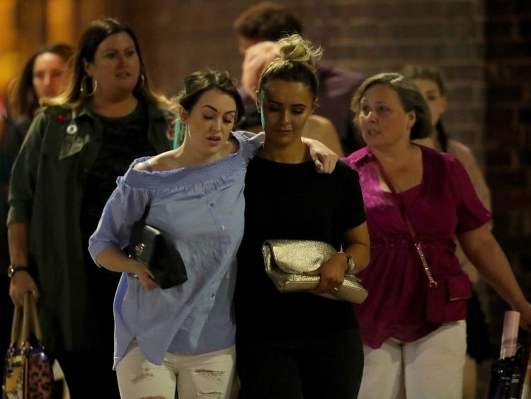 Police escort members of the public from Manchester Arena after and explosion at Ariana Grande gig