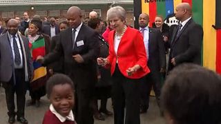 Theresa May dances outside a school in Cape Town