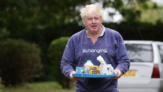 Boris Johnson brings tea for the press to drink outside his house 