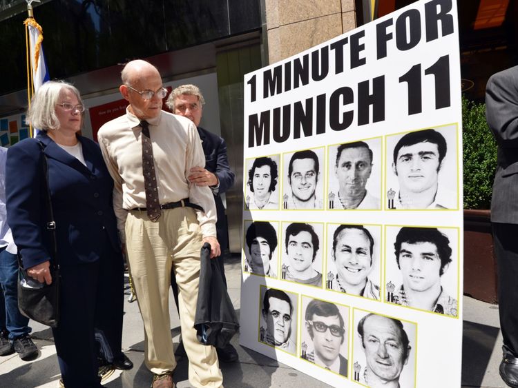 Avi Melamed (2nd L), surviving member of the 1972 Israeli Olympic team, walks past a poster after he joined Jewish and New York community members in a moment of silence July 27, 2012 in New York to honor the 11 Israeli Olympic athletes killed by Palestinian militants at the 1972 Munich games. AFP PHOTO/Stan HONDA (Photo credit should read STAN HONDA/AFP/GettyImages)
