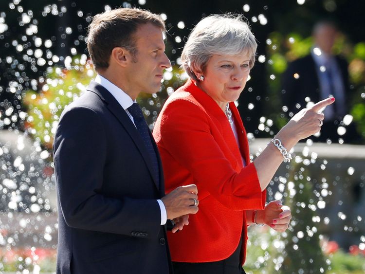 Theresa May and Emmanuel Macron arrive for a family photo during the European Union leaders informal summit in Salzburg