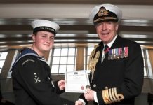 Sea cadet John Challenger being awarded a British Empire Medal (BEM) dressed in full service uniform.